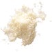A pile of white crumbs on a white background from a Robot Coupe Hard Cheese Grating Disc.