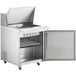 An Avantco stainless steel counter top refrigerator with a door open.