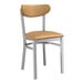 A Lancaster Table & Seating metal chair with a light brown vinyl seat and back.