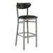 A Lancaster Table & Seating black bar stool with a chrome frame and black vinyl seat and back.