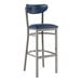 A Lancaster Table & Seating bar stool with a navy cushion and metal frame.