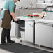 An Avantco worktop freezer on a stainless steel counter in a kitchen.