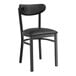 A black Lancaster Table & Seating metal chair with a black vinyl cushion.