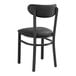 A Lancaster Table & Seating black metal chair with black vinyl seat and back.