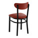 A black metal chair with a burgundy vinyl seat and backrest.