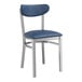 A Lancaster Table & Seating metal chair with navy vinyl seat and back on a white background.