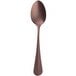 A vintage copper Sola stainless steel teaspoon with a long handle.