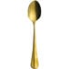 A gold Sola Baguette spoon with a long handle.