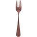 A Sola stainless steel cake fork with a copper colored handle.