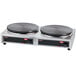 A Hatco Krampouz dual cast iron crepe maker with two pans on a surface.