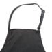 A black Chef Revival apron with a black strap.