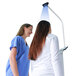 A woman in a blue shirt using a Cardinal Detecto clinical scale with sonar height rod.