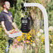 A black AvaWeigh digital hanging scale with a screen.