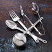 A close-up of Oneida Cooper stainless steel forks on a table.