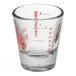 An Anchor Hocking measuring glass with red print on a counter.