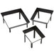 A black metal American Metalcraft square riser set with legs.