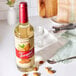 A Torani Puremade Almond flavoring syrup bottle on a counter.