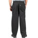 A man wearing Uncommon Chef black chef pants.