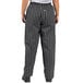 A person wearing black chef pants with white stripes.
