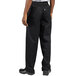 A person wearing Uncommon Chef black chef pants.