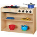 A natural wood toddler kitchen with pans on the stove.