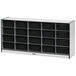 A white storage cabinet with black shelves holding black bins.