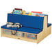 A Jonti-Craft double-sided wood couch with blue cushions and clear tubs of books.