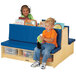 A group of kids sitting on a Jonti-Craft double-sided blue bench with clear tubs.