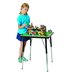 A girl playing with building blocks at an adjustable height Jonti-Craft table.