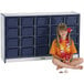 A young girl sitting in front of a Rainbow Accents navy and gray storage cabinet.