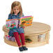 A girl reading a book on a Jonti-Craft Read-a-Round island with padded seats.