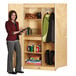 A woman standing next to a large Jonti-Craft wood wardrobe closet.