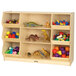 A Jonti-Craft wooden open storage cabinet filled with toys including a toy dinosaur with a red leafy tail.