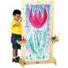 A young boy painting on a Jonti-Craft See-Thru Easel.