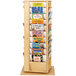 A Jonti-Craft wooden revolving book rack filled with children's books.