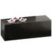 A black rectangular Cal-Mil plate riser with white bowls of red berries on it.