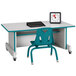 A Rainbow Accents teal computer desk with a chair and a clock on it.