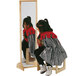 A little girl sitting on a stool looking at herself in a Jonti-Craft children's mirror with a wood frame.