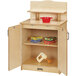 A Jonti-Craft wooden kitchen cabinet with toy food and a toy mixer on top.