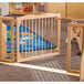 A wooden KYDZ Suite E-Height Welcome Gate in a classroom.