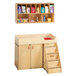 A Jonti-Craft wood diaper changing cabinet with shelves and cubbie trays.