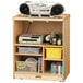 A Jonti-Craft wood media cart with shelves holding a cassette player and other items.