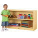 A child standing next to a Jonti-Craft wood storage cabinet with colorful blocks on the shelves.