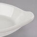 A Hall China oval rarebit dish in white on a gray surface.