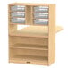 A white wood Jonti-Craft children's table with a wooden rotating shelf and plastic bins.