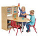 A boy and a girl sitting at a Jonti-Craft wood table playing with toys.