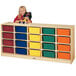 A young girl standing next to a Jonti-Craft wood storage cabinet with colored bins.