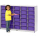 A young girl standing next to a Rainbow Accents purple storage unit with purple tubs.