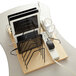 A Jonti-Craft tabletop wood tablet charging station on a table with white tablets charging.