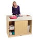 A woman standing next to a Jonti-Craft wood baby changing cabinet.